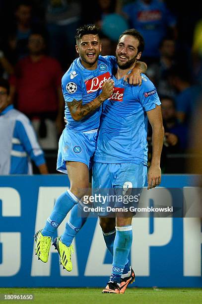Gonzalo Higuain of SSC Napoli celebrates with teammate Lorenzo Insigne after heading his team's first goal during the UEFA Champions League Group F...