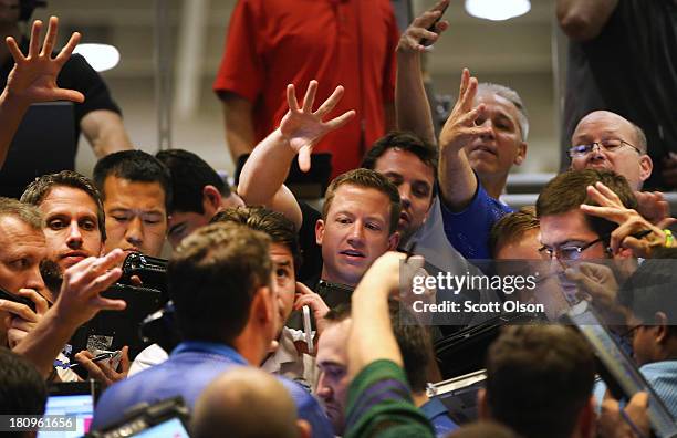 Traders signal offers in the Standard & Poor's 500 stock index options pit at the Chicago Board Options Exchange following the Federal Open Market...