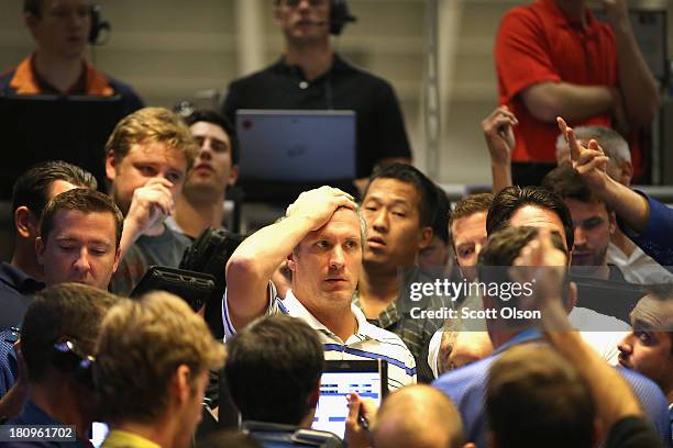 Traders signal offers in the Standard & Poor's 500 stock index options pit at the Chicago Board Options Exchange following the Federal Open Market...