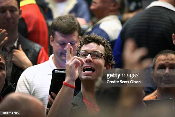 Traders signal offers in the Standard & Poor's 500 stock index options pit at the Chicago Board Options Exchange following the Federal Open Market...