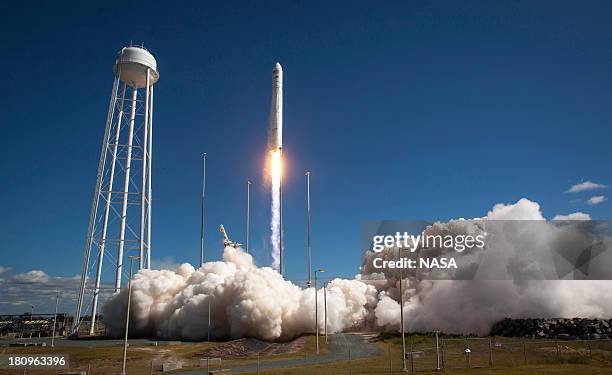 In this handout from NASA, the Orbital Sciences Corporation Antares rocket, with the Cygnus cargo spacecraft aboard, launches from Pad-0A of the...