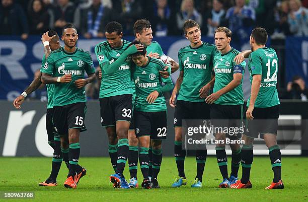 Atsuto Uchida of Schalke celebrates scoring the opening goal with team mate Joel Matip during the UEFA Champions League Group E match between FC...