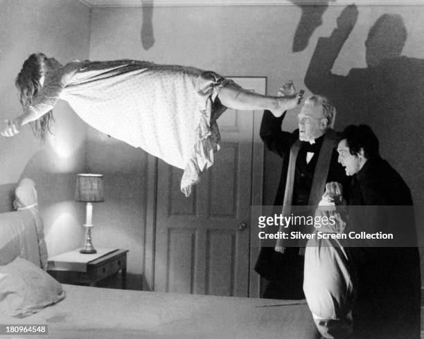 Linda Blair as Regan MacNeil, Max von Sydow as Father Merrin, and Jason Miller as Father Karras in 'The Exorcist', directed by William Friedkin, 1973.