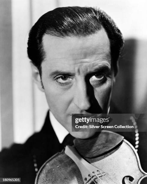 British actor Basil Rathbone , as Sherlock Holmes, in a promotional portrait for one of the fourteen films in which he played the role, circa 1942.