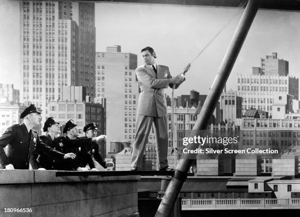 American swimmer and actor Johnny Weissmuller , as Tarzan, in 'Tarzan's New York Adventure', directed by Richard Thorpe, 1942.