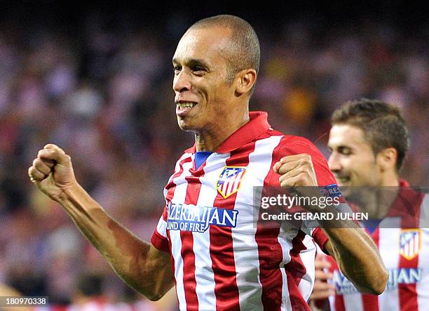 Atletico Madrid's Brazilian defender Joao Miranda de Souza celebrates after scoring during the UEFA Champions league football match Atletico de...