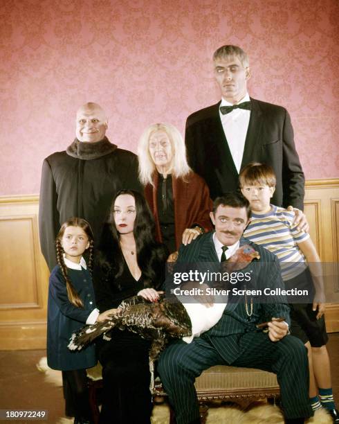 The cast of the US TV comedy horror series 'The Addams Family', circa 1965. Back row, left to right: Jackie Coogan as Uncle Fester, Blossom Rock as...