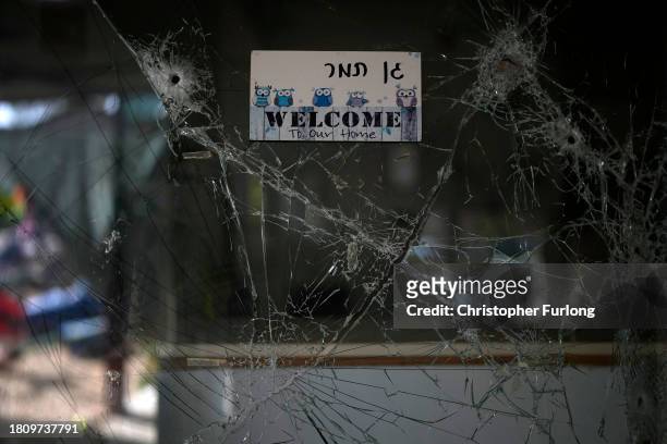 Bullet hole is seen in the window of a kindergarten and nursery school destroyed during the attack by Hamas at Kibbutz Be'eri on November 23, 2023 in...
