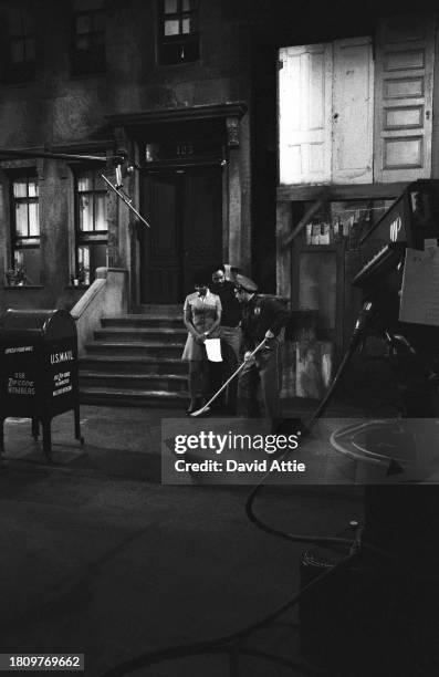 Actress Loretta Long and actor Matt Robinson talk to a street-cleaner character during the taping of Sesame Street's very first season, taken for...