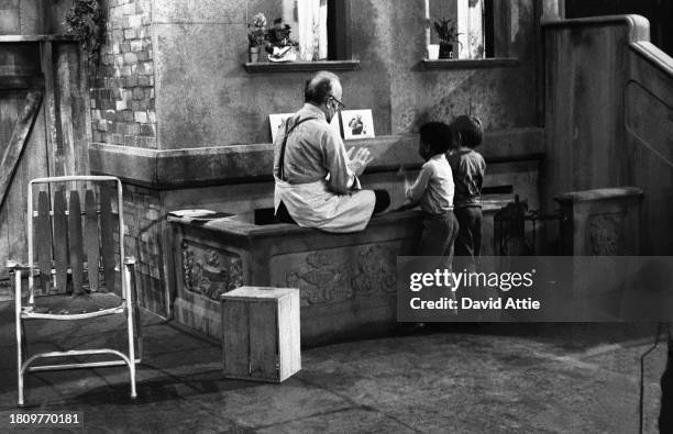 Actor Will Lee with two children during the taping of Sesame Street's very first season, taken for America Illustrated Magazine, at Reeves TeleTape...