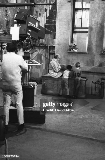 Actor Will Lee is filmed talking with two children during the taping of Sesame Street's very first season, taken for America Illustrated Magazine, at...