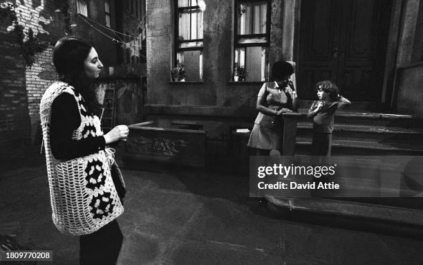 Actress Loretta Long talks to the photographer's son, Oliver Attie, while the photographer's wife Dotty Attie looks on, during a break in the taping...