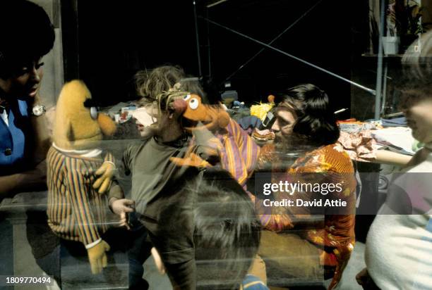 Photo montage of puppeteer Jim Henson , holding Ernie, and puppeteer Frank Oz , holding Bert, entertaining children, superimposed over actress...