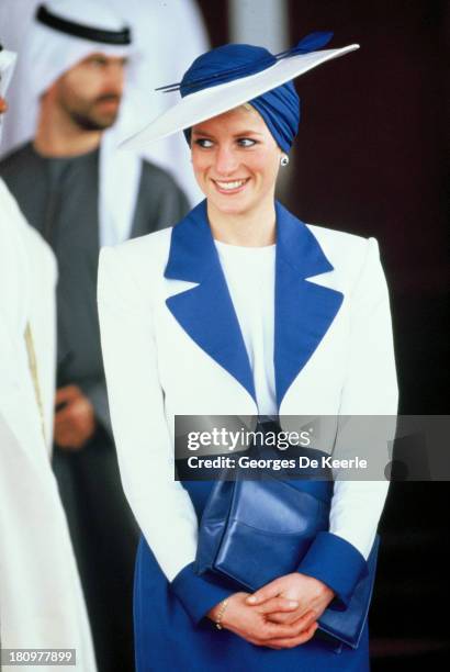 Diana, Princess of Wales, wears a Catherine Walker suit and a Philip Somerville turban hat during her official tour of the Gulf States on March 17,...