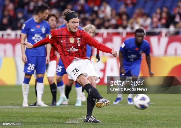 Japan's Urawa Reds defender Alexander Scholz scores an opening goal on penalty kick during the first half of a match against China's Wuhan Three...