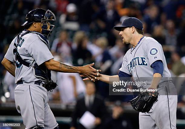 Danny Farquhar of the Seattle Mariners is congratulated by catcher Henry Blanco after pitching the ninth inning of a 8-0 win over the Detroit Tigers...