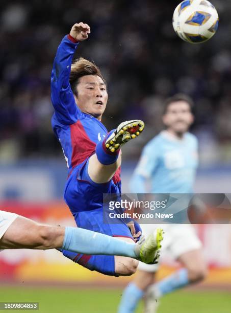 Japan's Ventforet Kofu midfielder Yoshiki Torikai scores the second goal for the team during the first half of a match against Australia's Melbourne...