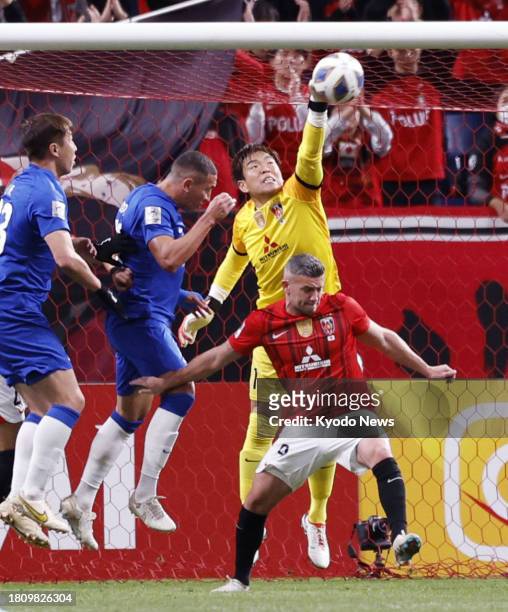 Japan's Urawa Reds goalkeeper Shusaku Nishikawa punches the ball away during the first half of a match against China's Wuhan Three Towns in the Asian...
