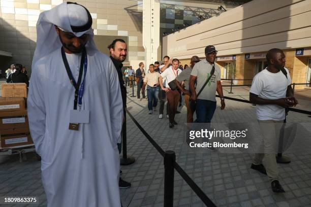 Attendees queue to enter the Blue Zone ahead of the COP28 climate conference at Expo City in Dubai, United Arab Emirates, on Wednesday, Nov. 29,...