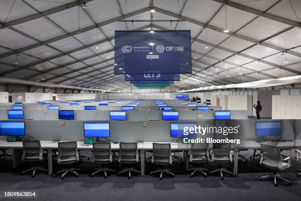 Empty work stations inside the media center within the Blue Zone ahead of the COP28 climate conference at Expo City in Dubai, United Arab Emirates,...