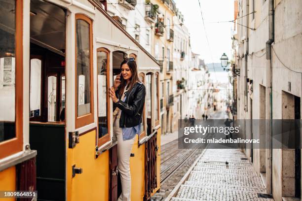 young female tourist enjoying in old european town - lissabon stockfoto's en -beelden