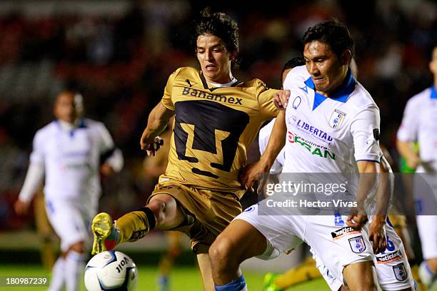 Carlos Orrantia of Pumas struggles for the ball with Manuel Escalante of Queretaro during a match between Queretaro and Pumas as part of the Copa MX...