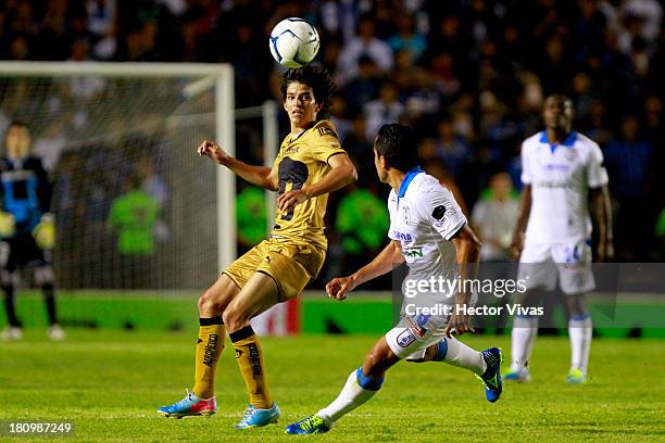 Carlos Orrantia of Pumas struggles for the ball with Luis Esqueda of Queretaro during a match between Queretaro and Pumas as part of the Copa MX at...