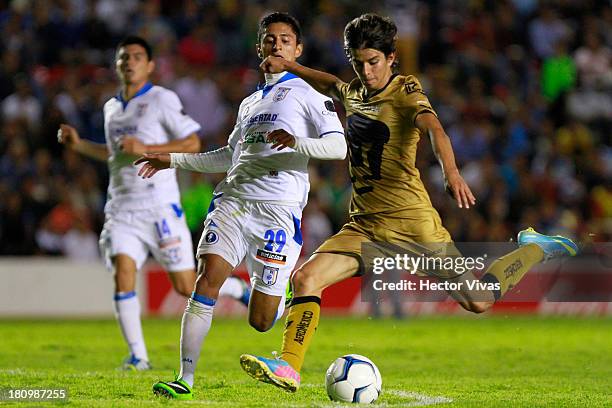 Carlos Orrantia of Pumas struggles for the ball with Julio Cesar Nava of Queretaro during a match between Queretaro and Pumas as part of the Copa MX...