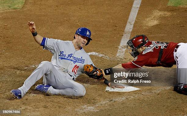 Michael Young of the Los Angeles Dodgers is called out on a tag by catcher Miguel Montero of the Arizona Diamondbacks during the sixth inning of a...