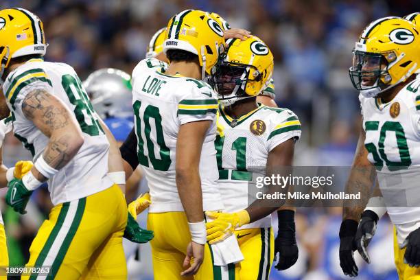 Jayden Reed of the Green Bay Packers celebrates with Jordan Love of the Green Bay Packers after scoring a touchdown against the Detroit Lions during...