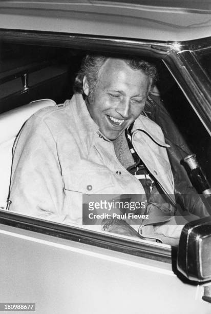 American stunt person Evel Knievel leaves London Airport after his arrival from the USA, 1975.