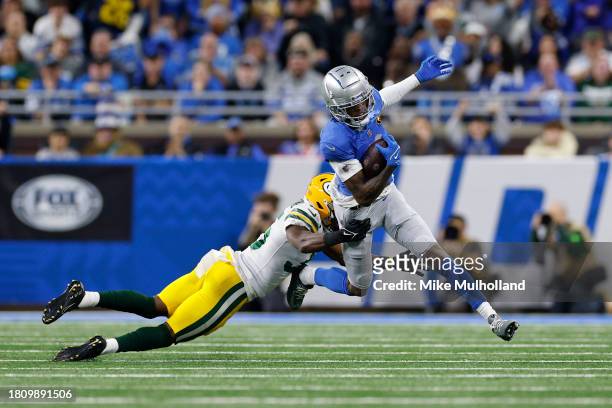Corey Ballentine of the Green Bay Packers tackles Jameson Williams of the Detroit Lions during the first quarter of the game at Ford Field on...