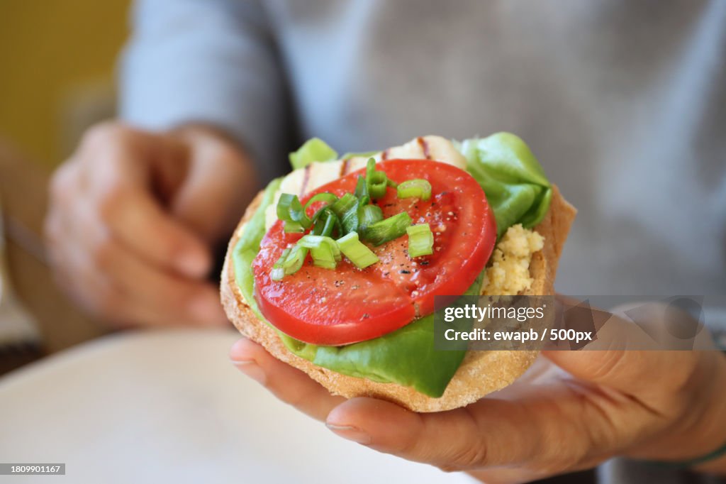 Midsection of woman holding burger,Pomorskie,Poland