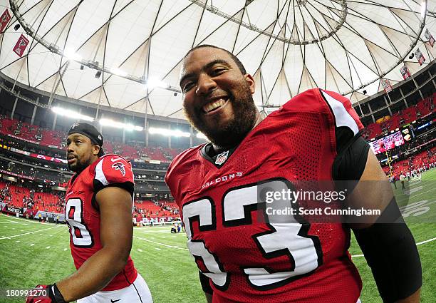 Justin Blalock and Cliff Matthews of the Atlanta Falcons head off the field after the game against the St. Louis Rams at the Georgia Dome on...