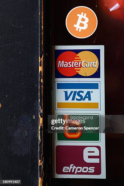 Sign displaying Bitcoins accepted is seen on the front door of the Old Fitzroy Pub on September 19, 2013 in Sydney, Australia. The Old Fitzroy pub in...