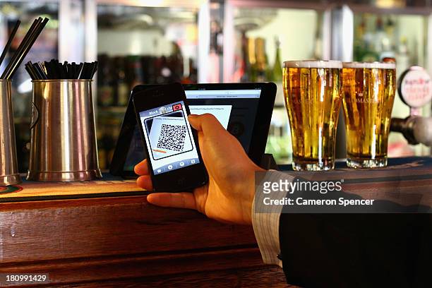 In this photo illustration, a customer scans a QR code to pay for drinks using bitcoins on September 19, 2013 in Sydney, Australia. The Old Fitzroy...