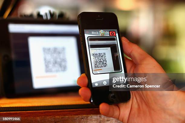 In this photo illustration, a customer scans a QR code to pay for drinks using bitcoins on September 19, 2013 in Sydney, Australia. The Old Fitzroy...