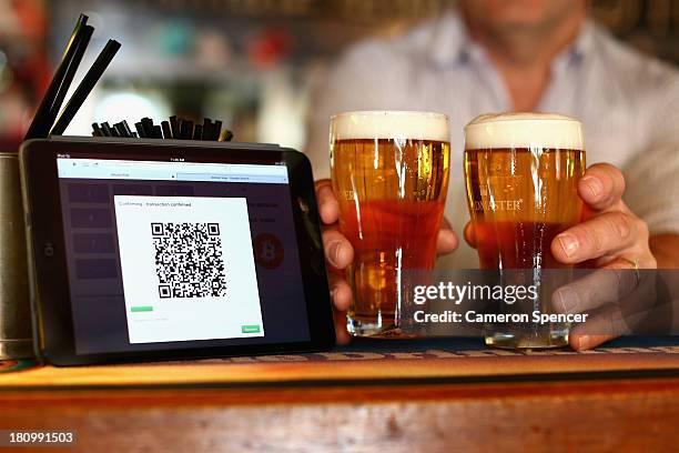 In this photo illustration, a terminal to accept payments using bitcoins is displayed on the bar at the Old Fitzroy pub on September 19, 2013 in...