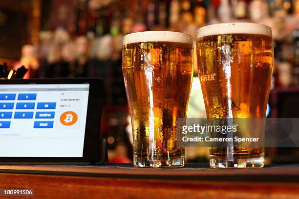 In this photo illustration, a terminal to accept payments using bitcoins is displayed on the bar at the Old Fitzroy pub on September 19, 2013 in...