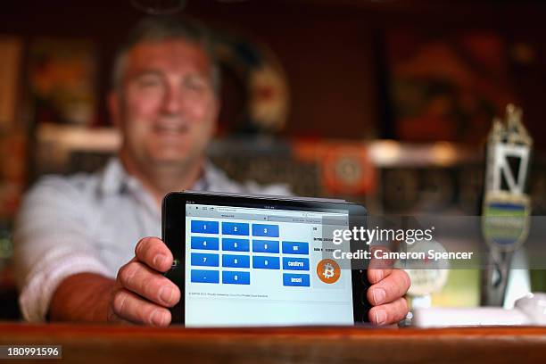 In this photo illustration, a terminal to accept payments using bitcoins is displayed on the bar at the Old Fitzroy pub on September 19, 2013 in...