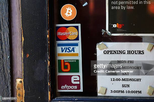Sign displaying Bitcoins accepted is seen on the front door of the Old Fitzroy Pub on September 19, 2013 in Sydney, Australia. The Old Fitzroy pub in...