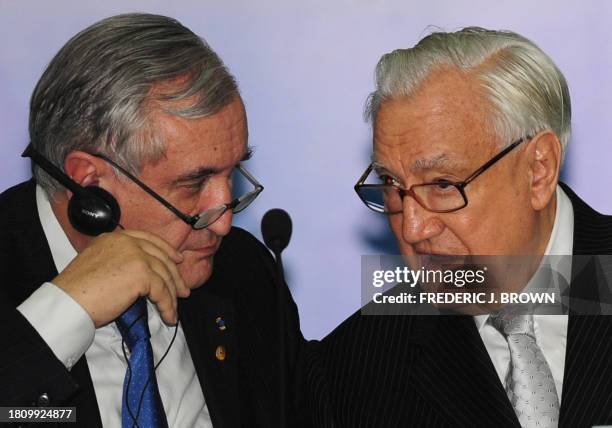 Former French prime minister Jean-Pierre Raffarin confers with French Senate president Christian Poncelet during a forum on Sino-European relations...