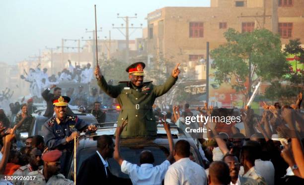 Sudanese President Omar al-Beshir parades in the streets of Khartoum and waves to supporters on March 4, 2009 after the International Criminal Court...