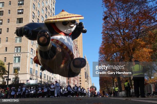 The Kung Fu Panda's Po balloon floats down Central Park West with Red Titan from Ryan's World balloon during the Macy's Thanksgiving Day Parade on...