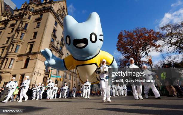 The Blue Cat and Chugs balloon floats down Central Park West during the Macy's Thanksgiving Day Parade on November 23 in New York City.