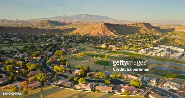 aerial view of suburban houses built around golf course in st. george, utah at sunset - drought city stock pictures, royalty-free photos & images