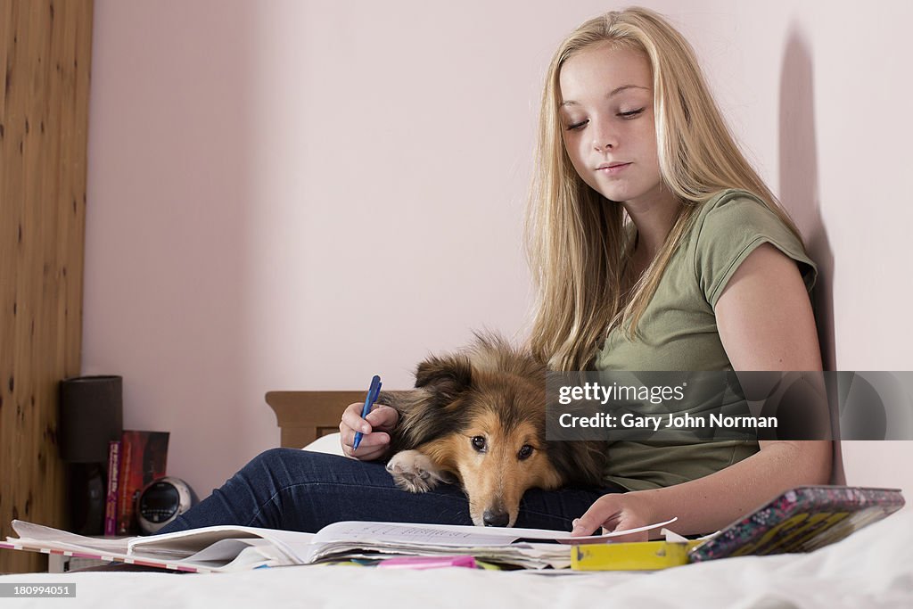 Teenage girl in her bedroom with her dog