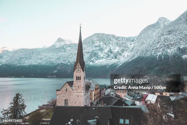 high angle view of church by lake against sky - church tower restoration appeal stock pictures, royalty-free photos & images