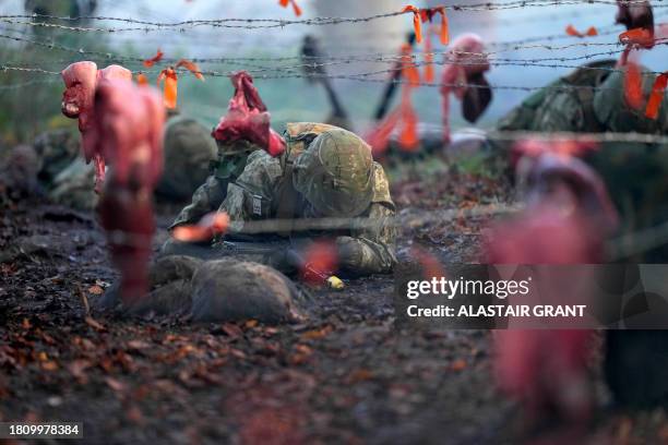 Ukrainian soldiers take part in a training excercise at the STANTA training camp in eastern England, on November 29 where Swedish military personnel...