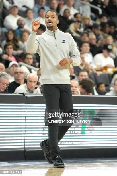 Head coach Kim English of the Providence Friars signals to his players during a college basketball game against the Wisconsin Badgers at Amica Mutual...